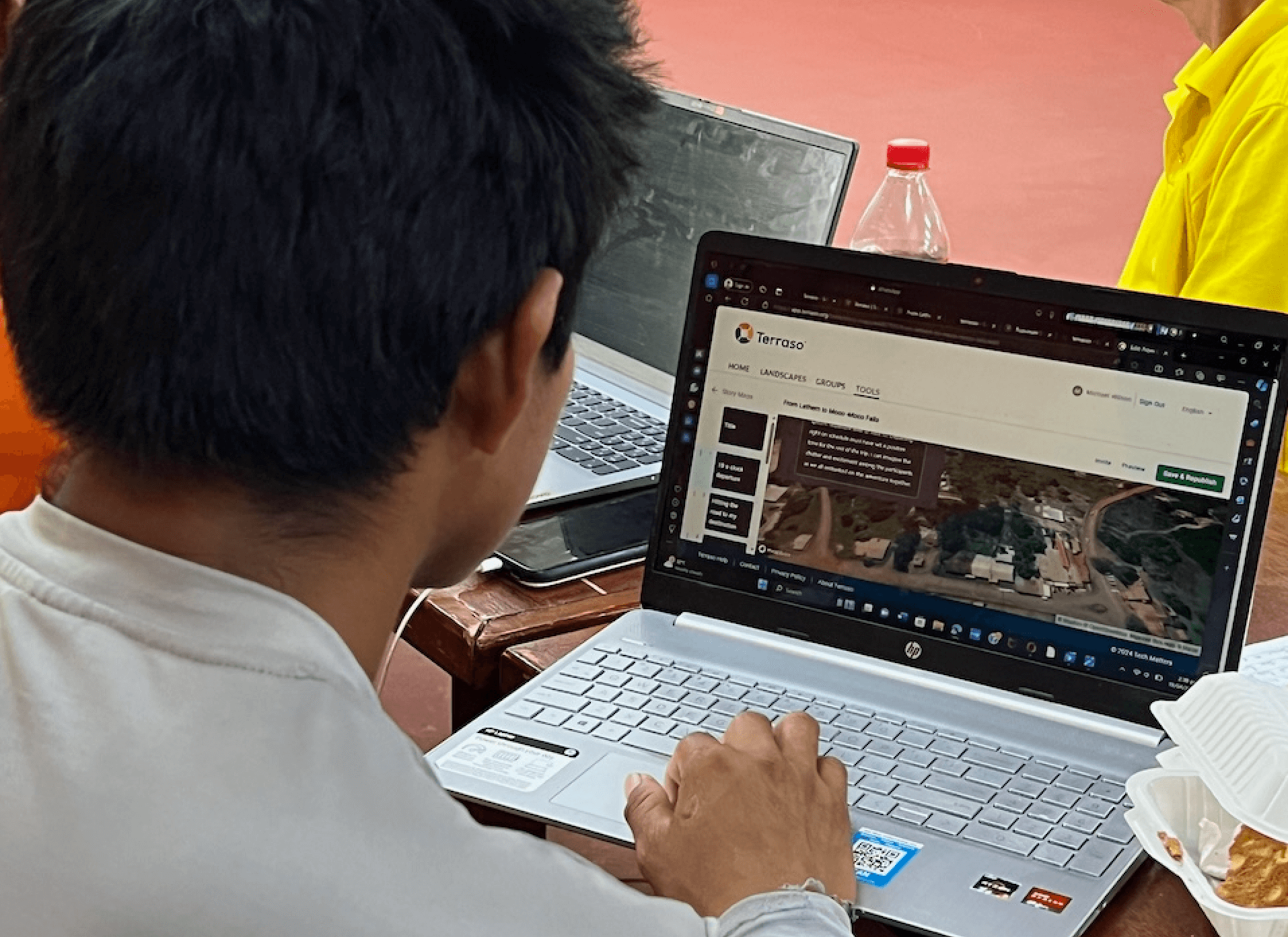 A man looks at a laptop as he creates a story map